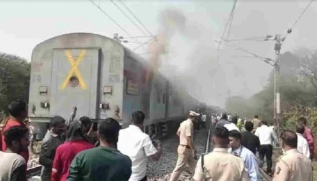 Train compartment of Lokmanya Tilak Terminus-Gorakhpur Express with smoke coming out due to fire caused by brake jam near Thakurli station, Thane district, Maharashtra.